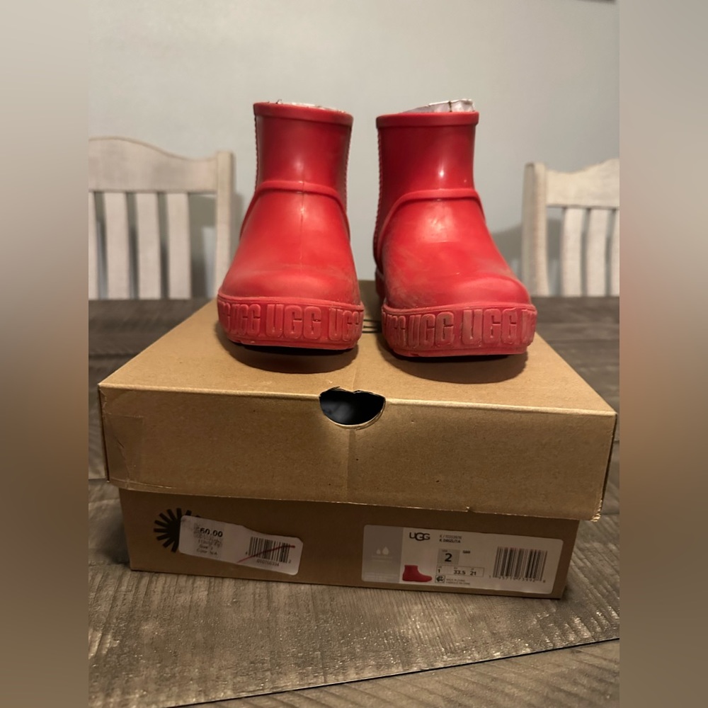 Girls red Ugg rain boots.